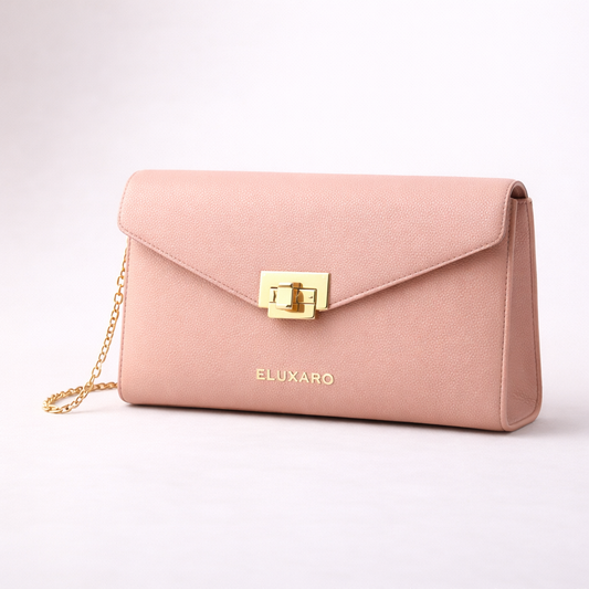 Pink handbag with gold chain and clasp on a light pink background